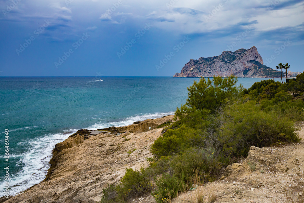 Panoramic view of the Ifach Rock Natural Park or Penon de Ifach in the city of Calpe in Spain. View from Moraira Costa Blanca. Panoramic view of the Ifach Rock Natural Park or Penon de Ifach in the city of Calpe in Spain. View from Moraira Costa Blanca.