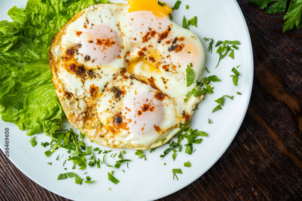 Flat lay of tasty breakfast over grey concrete table background. Fried eggs, micro greens, fresh tomatoes in plate, top view. Clean eating, dieting, vegetarian food - Image Flat lay of tasty breakfast over grey concrete table background. Fried eggs, micro greens, fresh tomatoes in plate, top view. Clean eating, dieting, vegetarian food - Image