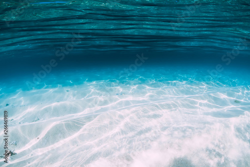 Tropical blue ocean with white sand underwater in Hawaii