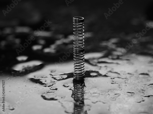 closeup of metal spring on wooden background