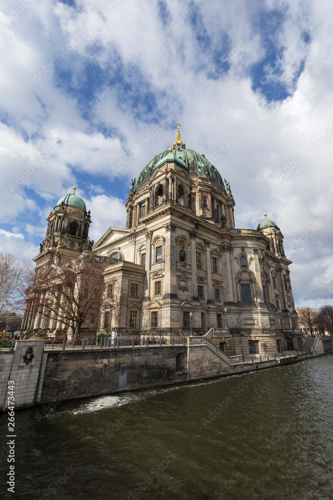 Beautiful view of the historic landmark Berliner Dom (Berlin Cathedral) by the Spree River in Berlin, Germany, on a sunny day.