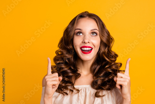 Close-up portrait of her she nice attractive stunning well-groomed lovely cheerful cheery positive wavy-haired lady pointing two forefingers up isolated over bright vivid shine yellow background