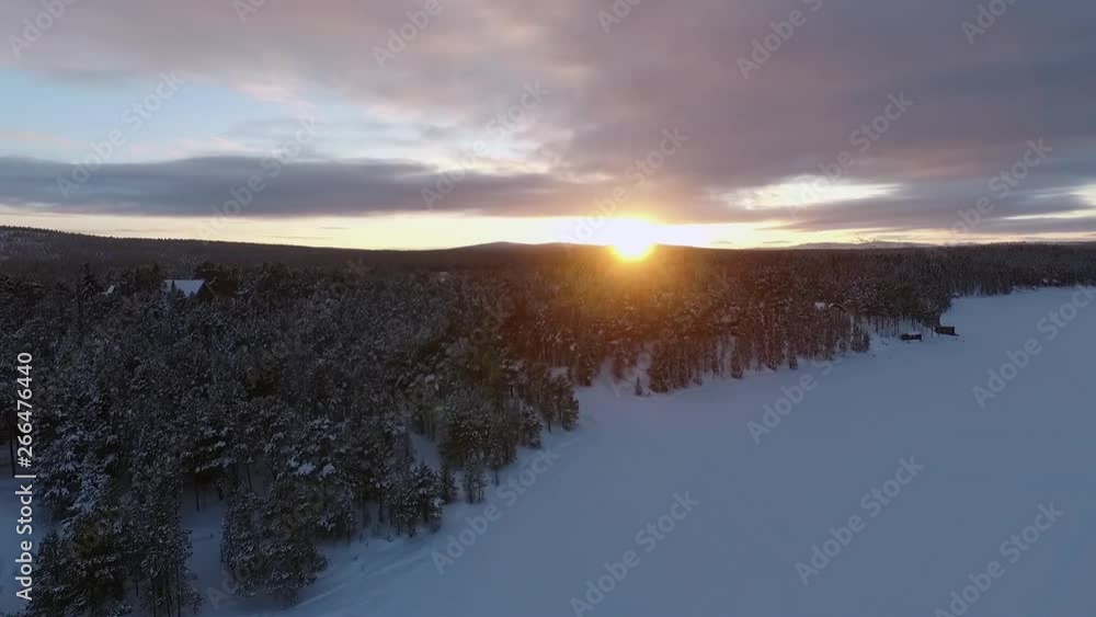 Fining into the orange sunset in Lapland in Sweden.