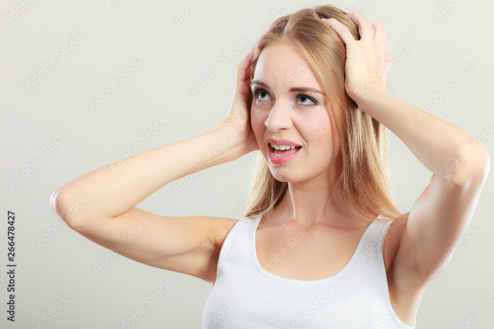 Closeup stressed woman covers ears with hands Closeup stressed woman covers ears with hands