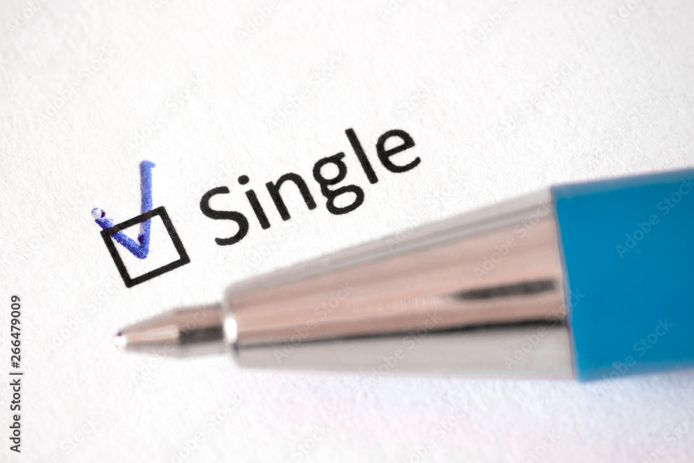 Questionnaire – blue pen and the inscription SINGLE with check mark on the white paper Questionnaire – blue pen and the inscription SINGLE with check mark on the white paper