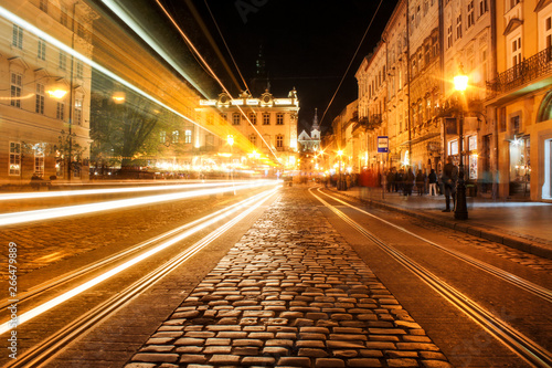 Lviv panorama at night. View of the night street of the European medieval city. Lviv Market square at night.  Concept  - travel, landmarks. FROZEN LIGHT FROM TRAM. Long exposure © Oleksandra