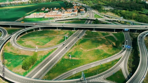 Aerial top down view on multilevel interchange overpass in Zbraslav showing afternoon traffic under sun and cloud photo