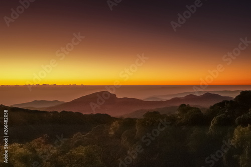 sunrise at Doi Inthanon National Park, mountain view morning of Doi Hua Suea top mountain around with soft fog with red sky background, Kew Mae Pan View Point, Chiang Mai, Thailand.
