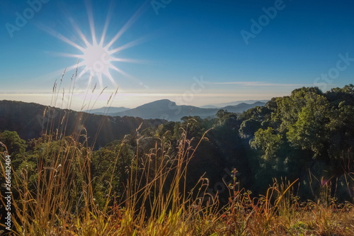 sunrise at Doi Inthanon National Park, mountain view morning of Doi Hua Suea top mountain around with soft fog with blue sky background, Kew Mae Pan View Point, Chiang Mai, Thailand.