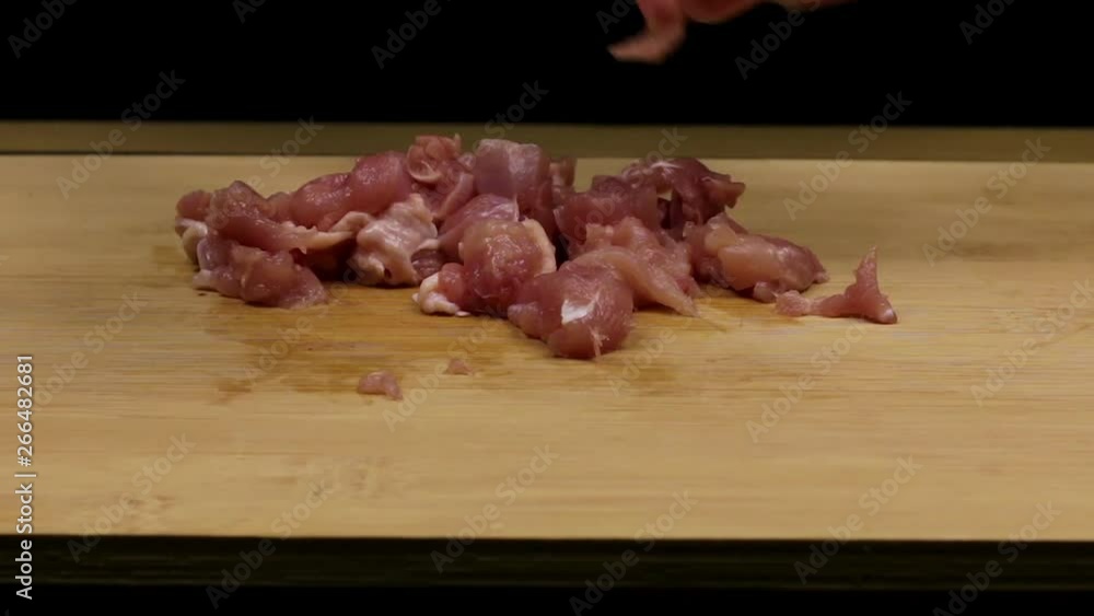 Cutting and slicing chicken fillets as part of the homemade recipe or preparation of chicken meat. Close Cutting and slicing chicken fillets as part of the homemade recipe or preparation of chicken meat. Close