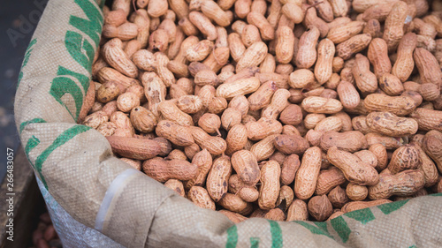 Bag of row peanuts at the market. Closeup peanut in the nutshell 
