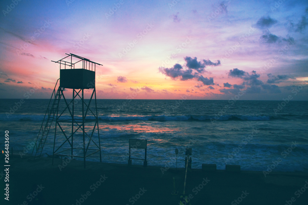 Sunset in Colombo. Ocean sunset. Saveguard spot on the beach. Baywatch spot Sunset in Colombo. Ocean sunset. Saveguard spot on the beach. Baywatch spot