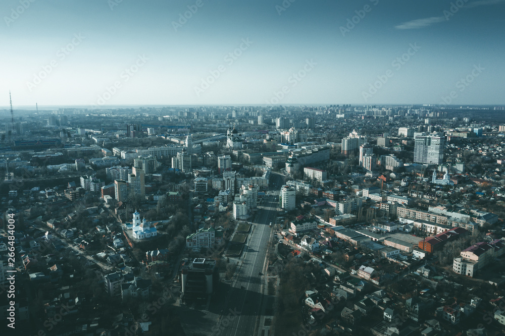 Aerial Voronezh city midtown panorama at sunset, roads with car traffic and buildings, center of old European city in spring, drone photo