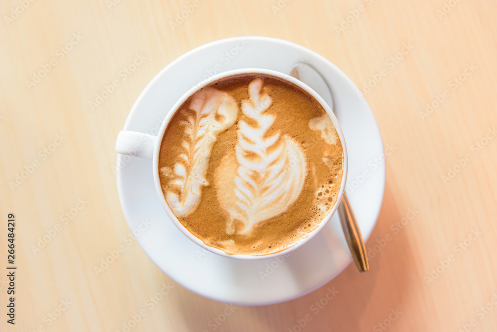 hot cappuccino coffee with nice pattern foam on table hot cappuccino coffee with nice pattern foam on table