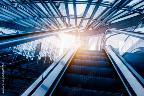 escalator of modern office building, blue toned images. photo
