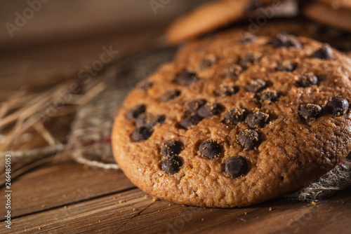 Fresh chocolate americana cookies on wooden table. Chocolate chip cookies on rural background.