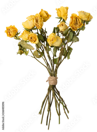 Dried yellow rosed bouquet isolated on white.