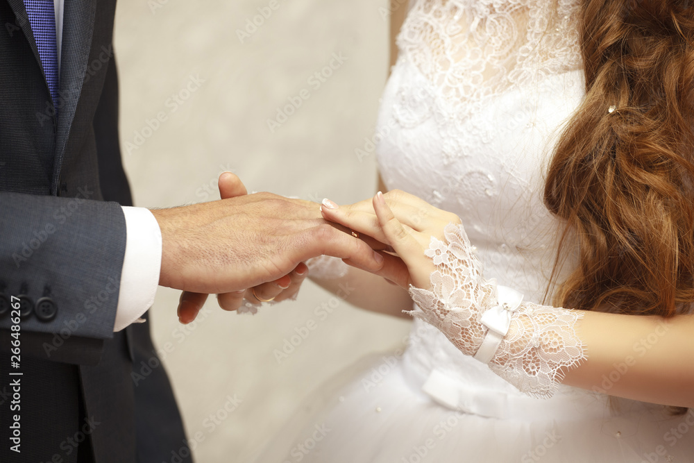 Wedding day. Ceremony. Wedding hands with rings. The bride's hand wears an engagement ring on the finger of the groom. Close up Wedding day. Ceremony. Wedding hands with rings. The bride's hand wears an engagement ring on the finger of the groom. Close up