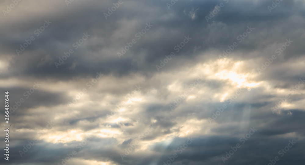 detailed view of a warm light crossing gray clouds detailed view of a warm light crossing gray clouds