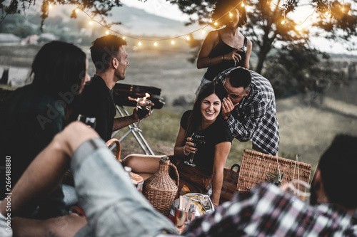 Sticker Happy friends having fun at bbq dinner with vintage lights outdoor drinking wine