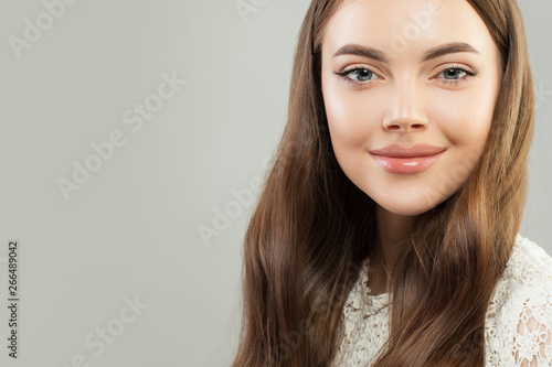Healthy young woman with clear skin and shiny hair smiling. Beautiful face close up