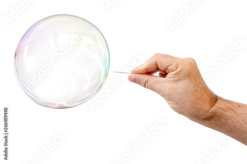 soap bubble and a males hand with needle to let it pop