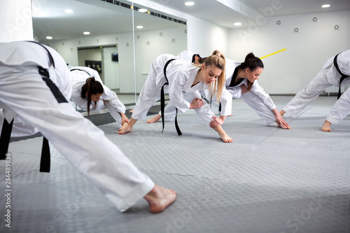 Fototapeta Martial art taekwondo combat fighters stretching and warming up