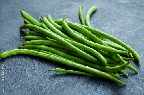 Green beans on grey stone background. Close up.