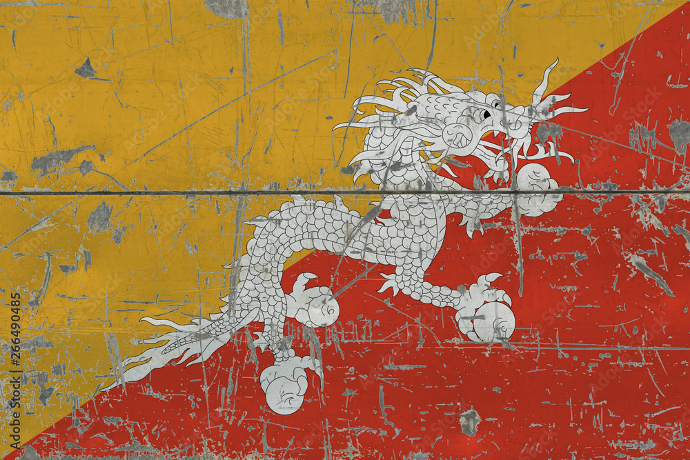Naklejka premium Grunge Bhutan flag on old scratched wooden surface. National vintage background.