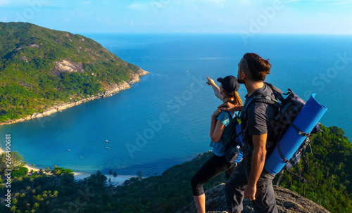 Wallpaper Mural Man and woman stand on on top of cliff in summer mountains at morning time and enjoying view of nature Torontodigital.ca