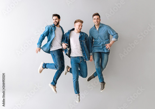 Jumping young men on light ...