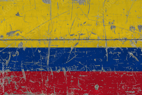 Grunge Colombia flag on old scratched wooden surface. National vintage background. © sezerozger