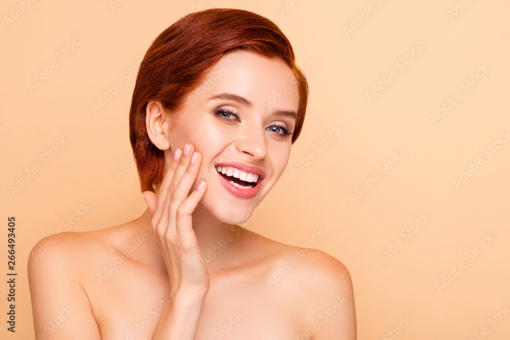 Close-up portrait of nice attractive lovely adorable charming cheerful positive glad girl touching cheek healthy skin vitality wellbeing wellness daily care isolated on beige pastel background Close-up portrait of nice attractive lovely adorable charming cheerful positive glad girl touching cheek healthy skin vitality wellbeing wellness daily care isolated on beige pastel background