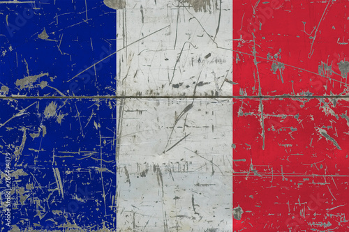 Grunge France flag on old scratched wooden surface. National vintage background. © sezerozger