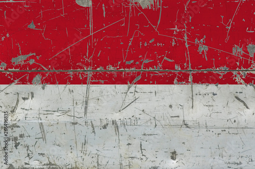 Grunge Indonesia flag on old scratched wooden surface. National vintage background. © sezerozger