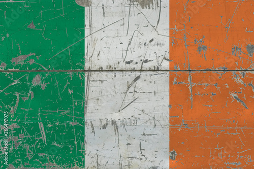 Grunge Ireland flag on old scratched wooden surface. National vintage background. © sezerozger