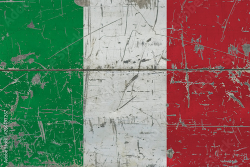 Grunge Italy flag on old scratched wooden surface. National vintage background. © sezerozger