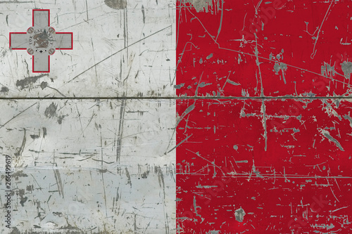 Grunge Malta flag on old scratched wooden surface. National vintage background. © sezerozger