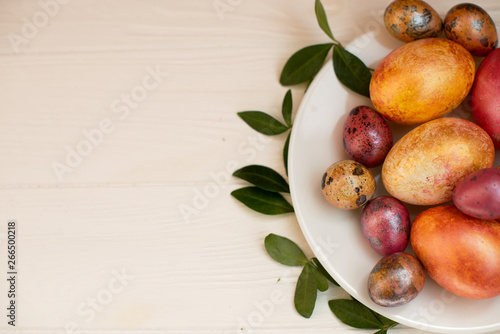 Easter eggs on the plate on a white background. Top view, close up, isolated. Concept happy easter. Preparation for the holiday. Place for text