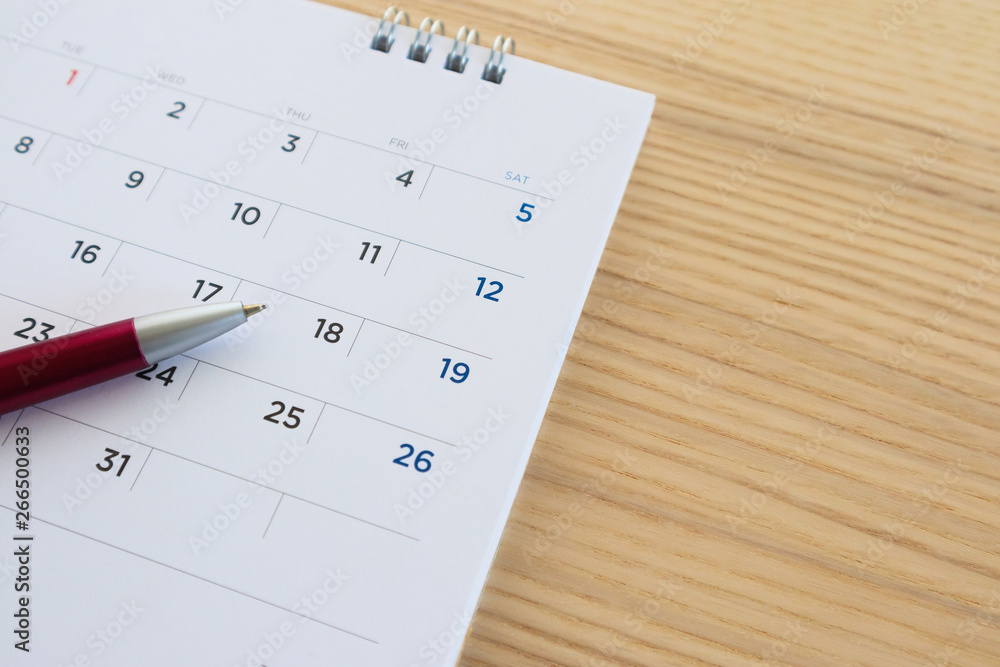 calendar page with pen on wood table background calendar page with pen on wood table background