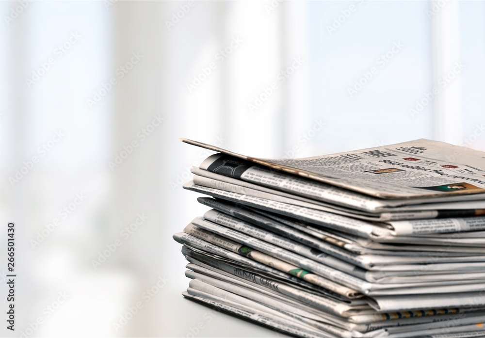 Pile of newspapers on white background Pile of newspapers on white background