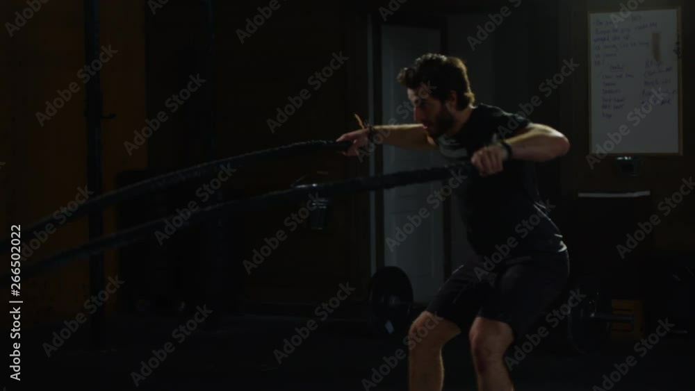 Young guy in crossfit gym working out Young guy in crossfit gym working out