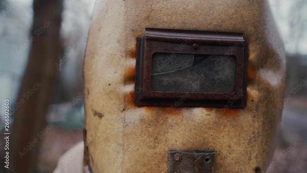 A close up shot of a scary old industrial welding mask turning left and right. A close up shot of a scary old industrial welding mask turning left and right.