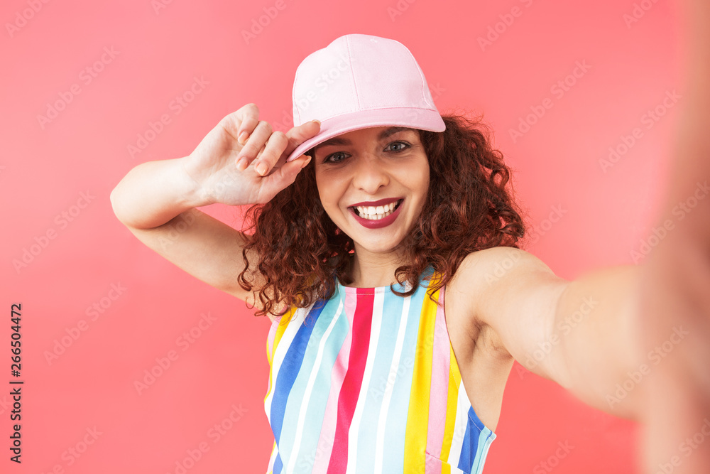 Smiling pretty redhead woman wearing in dress and cap Smiling pretty redhead woman wearing in dress and cap