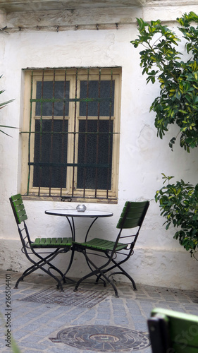 Spindly chairs in shady secluded courtyard