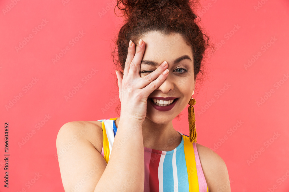 Joyful pretty redhead woman in dress covering her face Joyful pretty redhead woman in dress covering her face