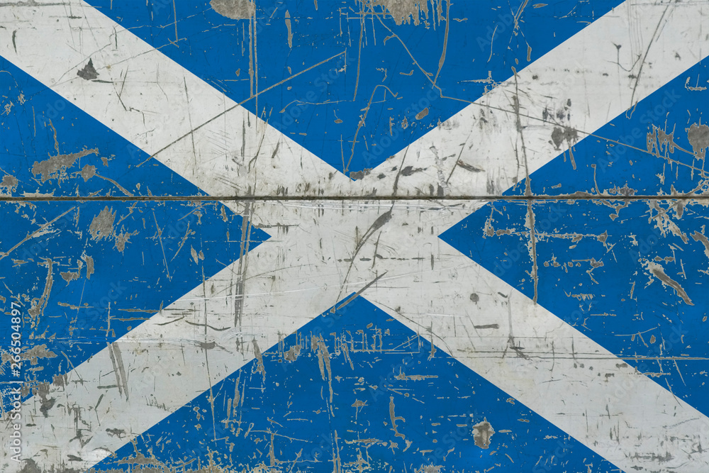 Obraz premium Grunge Scotland flag on old scratched wooden surface. National vintage background.