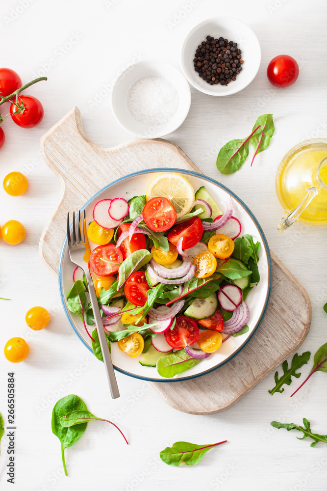 healthy colorful vegan tomato salad with cucumber, radish, onion healthy colorful vegan tomato salad with cucumber, radish, onion