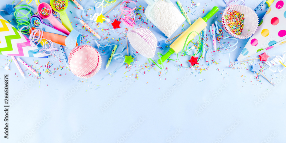 Sweet baking concept for birthday holiday party, cooking background with baking stuff - rolling pin, whipping whisk, cookie cutters, sugar sprinkling, flour. Light blue background, above copy space