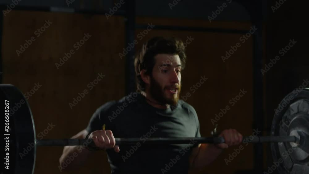 Young guy in crossfit gym working out Young guy in crossfit gym working out